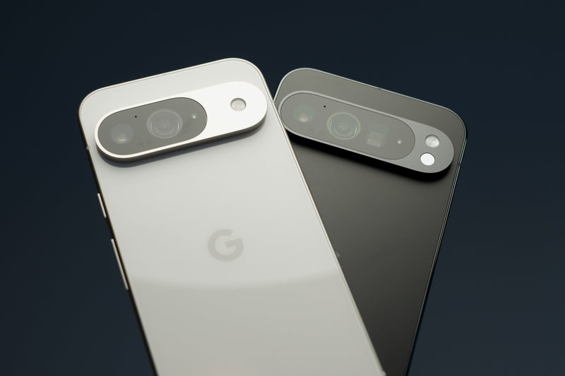 Two Google Pixel 9 phones, one is black and the other is white.