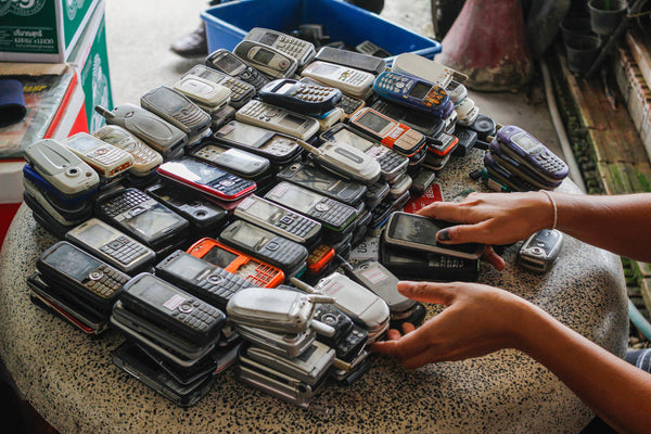 A pile of very old outdated phones.