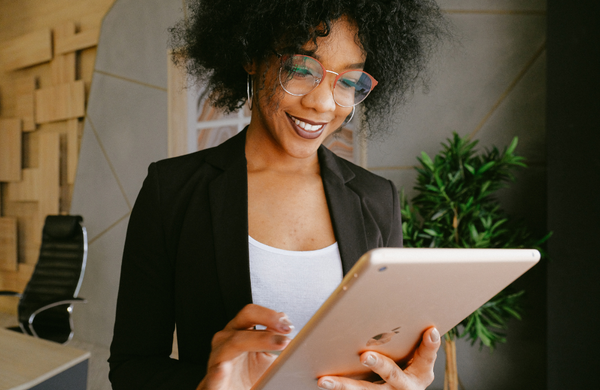 A business women holding an iPad in front of her. 