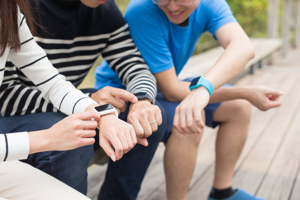 Three people comparing smartwatches. 